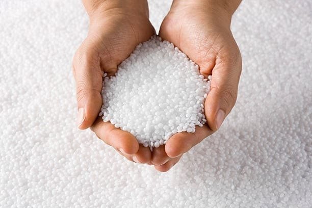 Pure white plastic pellets in hands prepared for plastic molding process